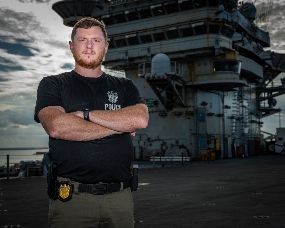 Naval Criminal Investigative Service (NCIS) Special Agent Afloat (SAA) Justin Botkin stand for an environmental portrait on the flight deck of the aircraft carrier USS Harry S. Truman (CVN 75) at Norfolk Naval Station Virginia on 19 September 2024.