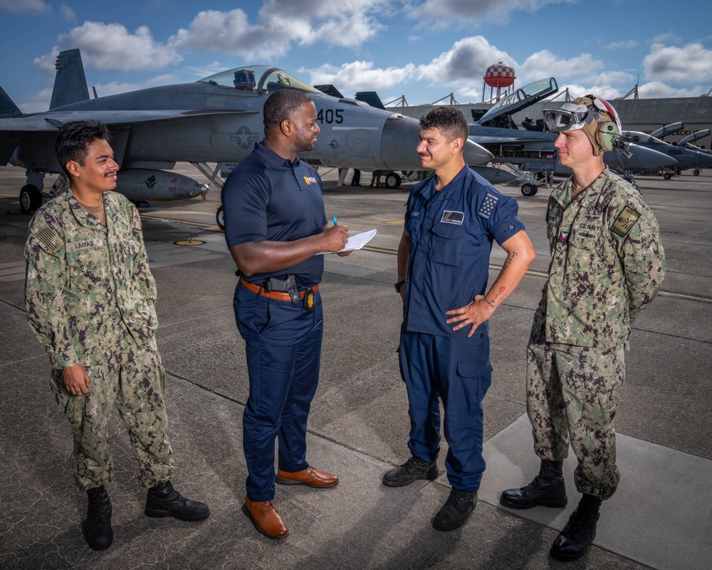 Naval Criminal Investigative Service (NCIS) Special Agent (SA) Kenneth Randle interviewing Aviation Electronics Technician (ATAN) Juan Lamas; ATAN Lucas Di Giacomo and Aviation Ordnancemen First Class (AO1) Jason Spire about an on-going investigation