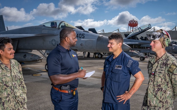Naval Criminal Investigative Service (NCIS) Special Agent (SA) Kenneth Randle interviewing Aviation Electronics Technician (ATAN) Juan Lamas; ATAN Lucas Di Giacomo and Aviation Ordnancemen First Class (AO1) Jason Spire about an on-going investigation