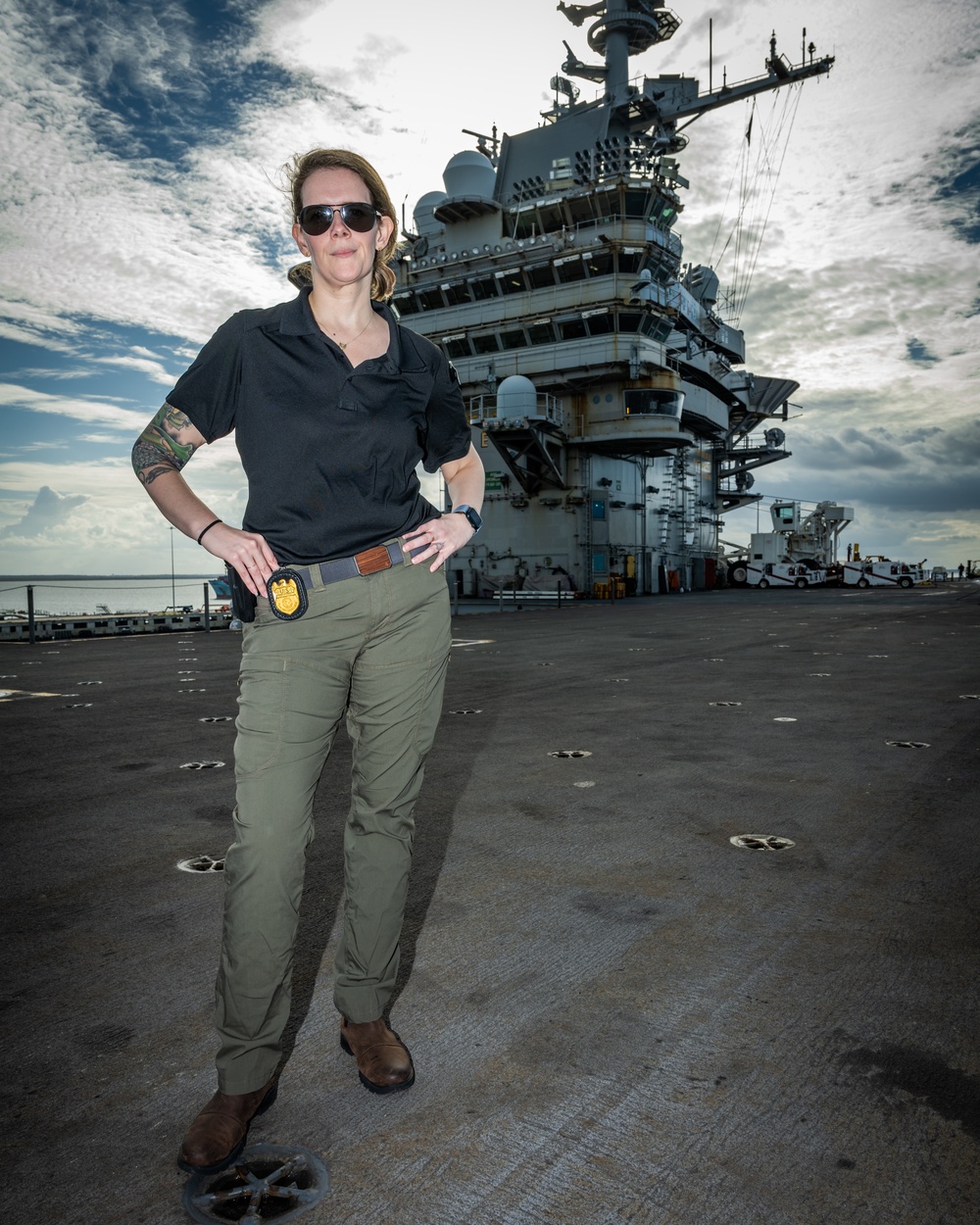 Naval Criminal Investigative Service (NCIS) Special Agent Afloat (SAA) Bernadette Duffy poses for an environmental portrait on the flight deck of the US Navy aircraft carrier USS Harry S. Truman (CVN 75)