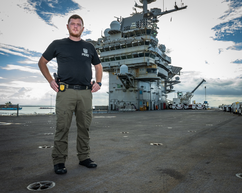 Naval Criminal Investigative Service (NCIS) Special Agent Afloat (SAA) Justin Botkin stand for an environmental portrait on the flight deck of the aircraft carrier USS Harry S. Truman (CVN 75)