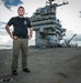 Naval Criminal Investigative Service (NCIS) Special Agent Afloat (SAA) Justin Botkin stand for an environmental portrait on the flight deck of the aircraft carrier USS Harry S. Truman (CVN 75)