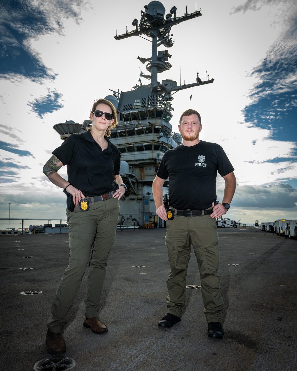 Naval Criminal Investigative Service (NCIS) Special Agents Afloat (SAA) Bernadette Duffy and Justin Botkin stand for an environmental portrait on the flight deck of the aircraft carrier USS Harry S. Truman (CVN 75)