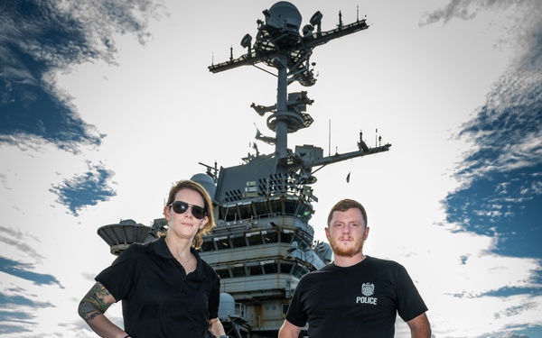 Naval Criminal Investigative Service (NCIS) Special Agents Afloat (SAA) Bernadette Duffy and Justin Botkin stand for an environmental portrait on the flight deck of the aircraft carrier USS Harry S. Truman (CVN 75)
