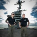 Naval Criminal Investigative Service (NCIS) Special Agents Afloat (SAA) Bernadette Duffy and Justin Botkin stand for an environmental portrait on the flight deck of the aircraft carrier USS Harry S. Truman (CVN 75)