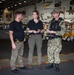 Special Agents Afloat (SAA) Bernadette Duffy and Justin Botkin talk with Master-at-Arms First Class (MA!) Travis Beckman about an on-going investigation in the hangar bay of the aircraft carrier USS Harry S. Truman (CVN 75)