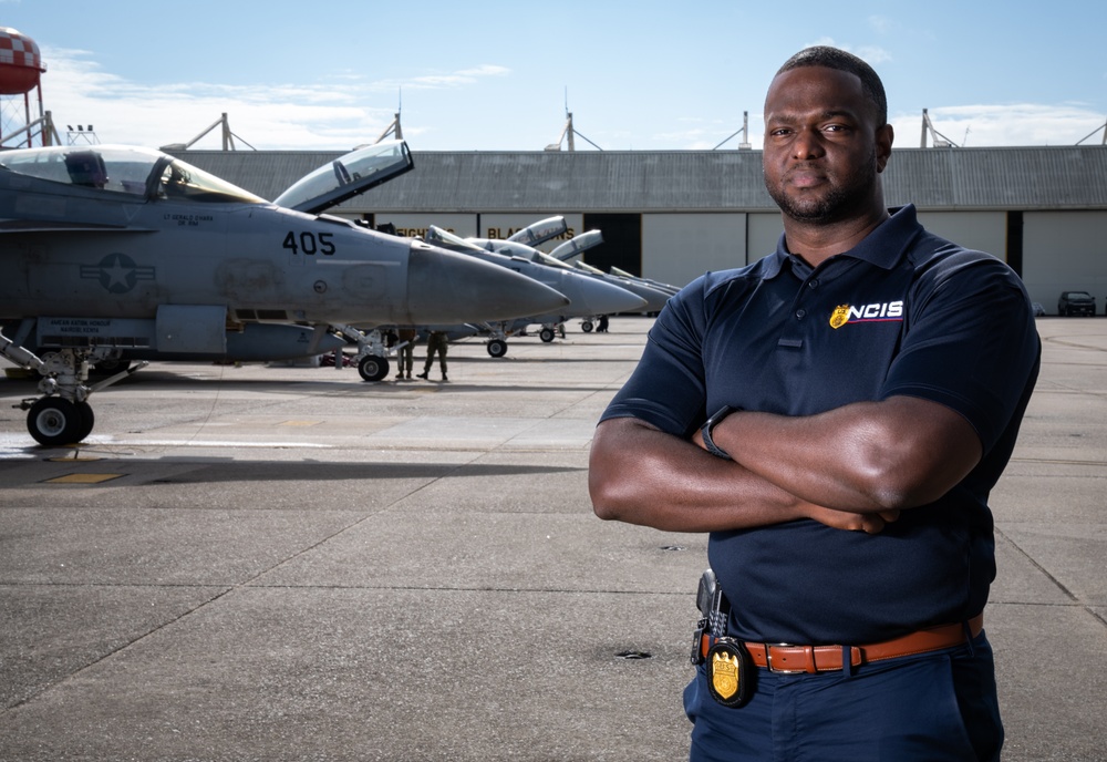 Environmental portrait of Naval Criminal Investigative Service (NCIS) Special Agent (SA) Kenneth Randle around the flight line with F-18 Hornets during the Naval Air Station (NAS) Oceana Airshow on 20 September 2024.