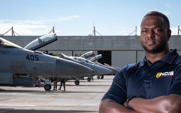 Environmental portrait of Naval Criminal Investigative Service (NCIS) Special Agent (SA) Kenneth Randle around the flight line with F-18 Hornets during the Naval Air Station (NAS) Oceana Airshow on 20 September 2024.