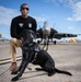 Naval Criminal Investigative Service (NCIS) Special Agent (SA) David Lawhorn and his K-9 companion Jill around the flight line with F-18 Hornets and the U. S. Navy's Flight Demonstration Team