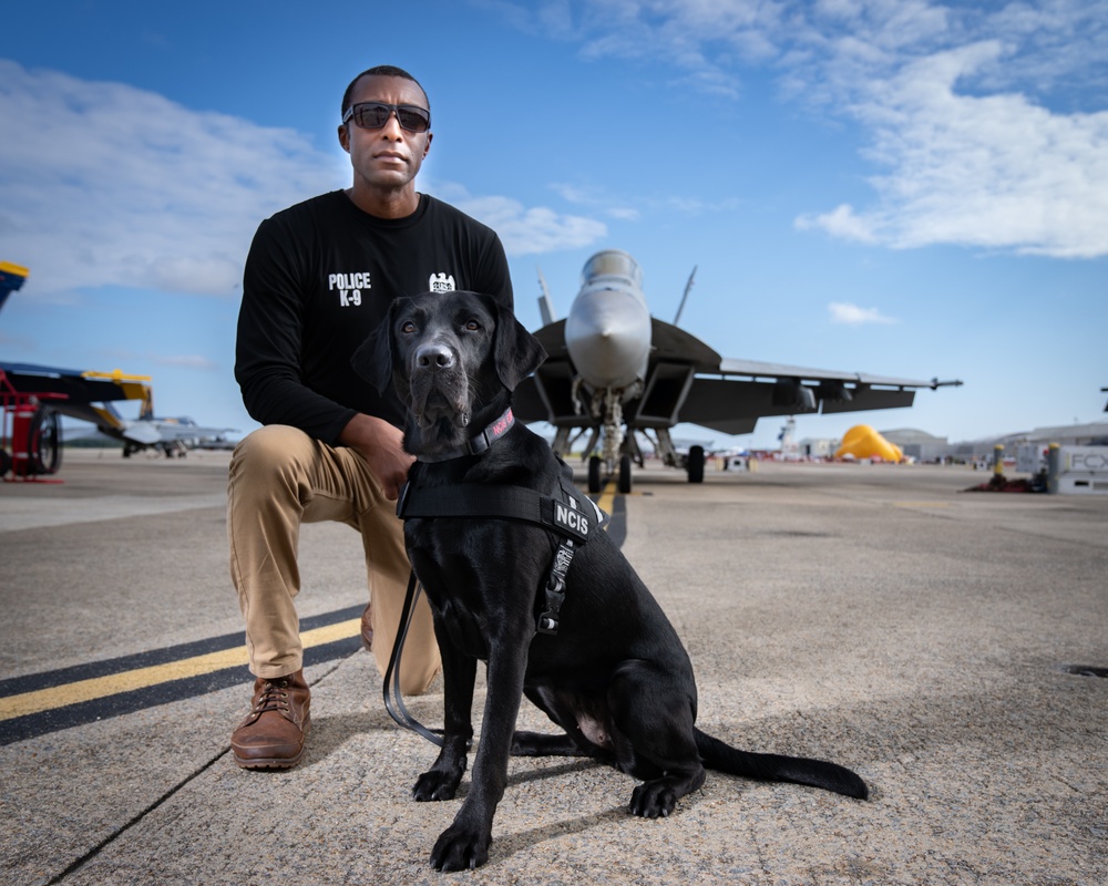 Naval Criminal Investigative Service (NCIS) Special Agent (SA) David Lawhorn and his K-9 companion Jill around the flight line with F-18 Hornets and the U. S. Navy's Flight Demonstration Team, Blue Angels