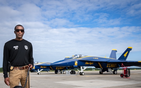 Naval Criminal Investigative Service (NCIS) Special Agent (SA) David Lawhorn and his K-9 companion Jill around the flight line with F-18 Hornets and the U. S. Navy's Flight Demonstration Team, Blue Angels