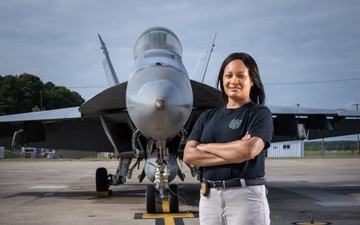 Naval Criminal Investigative Service (NCIS) Supervisory Special Agent (SSA) Jennifer Lynch around the flight line with F-18 Hornets