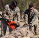 882nd Engineer Company, 505th Engineer Battalion, utilizes a chainsaw to remove debris