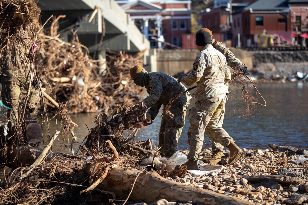 887th Engineer Company, 19th Engineer Battalion cuts off pieces of trees to clear debris in Marshall