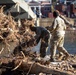 887th Engineer Company, 19th Engineer Battalion cuts off pieces of trees to clear debris in Marshall