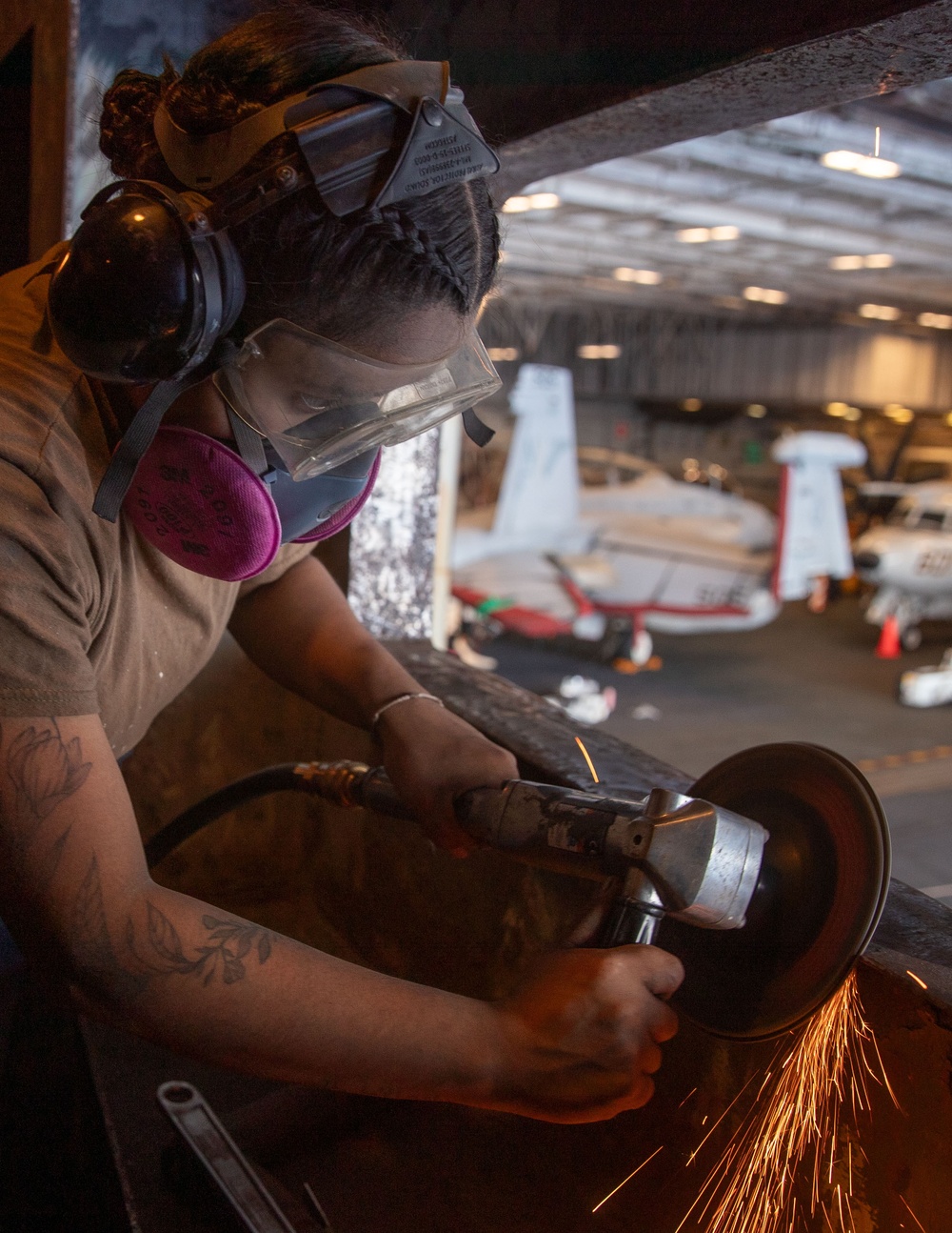 USS George Washington Sailor Grinds Metal for Paint Preparation