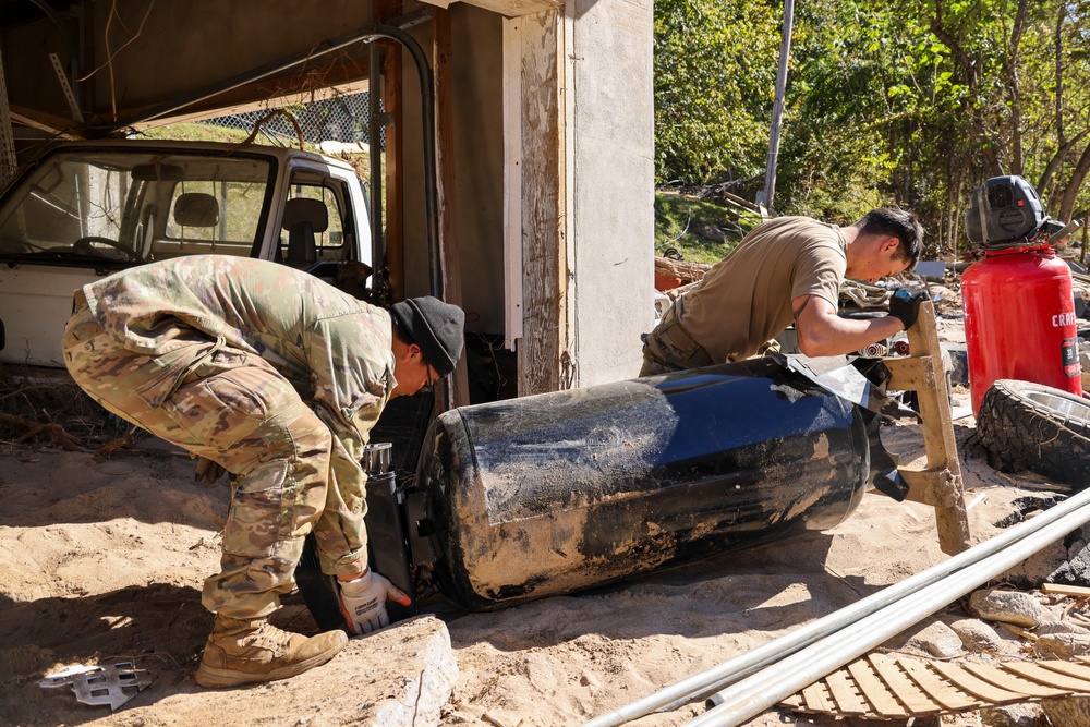 U.S. Army Soldiers assigned to Hardrock Company, 1-502 Infantry Regiment, 2nd Mobile Brigade Combat Team, 101st Airborne Division (Airborne), remove debris in Chimney Rock, North Carolina, Oct. 17, 2024.