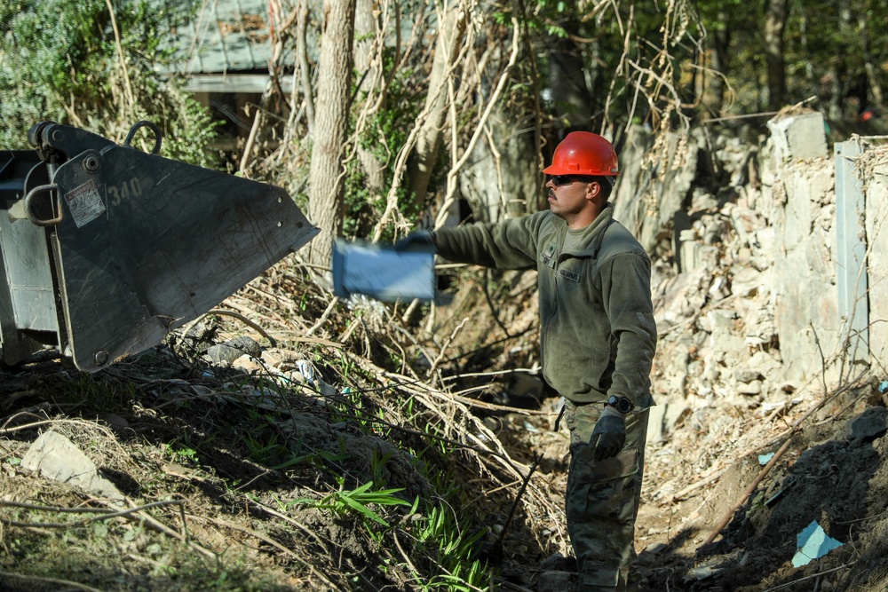 Tennessee Army National Guardsmen clear debris on Denton Road in Cocke County, Tennessee