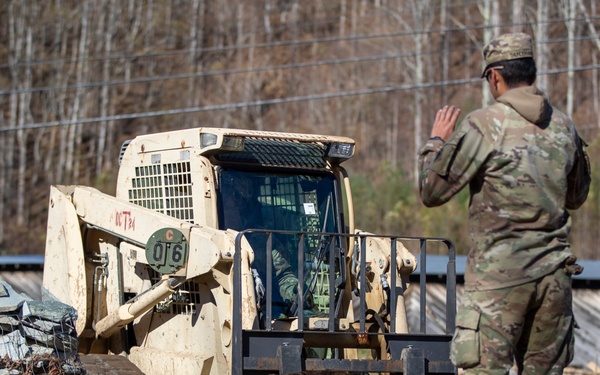 161st Engineer Support Company (Airborne) removes debris during route clearance near Green Creek in Bakersville, North Carolina