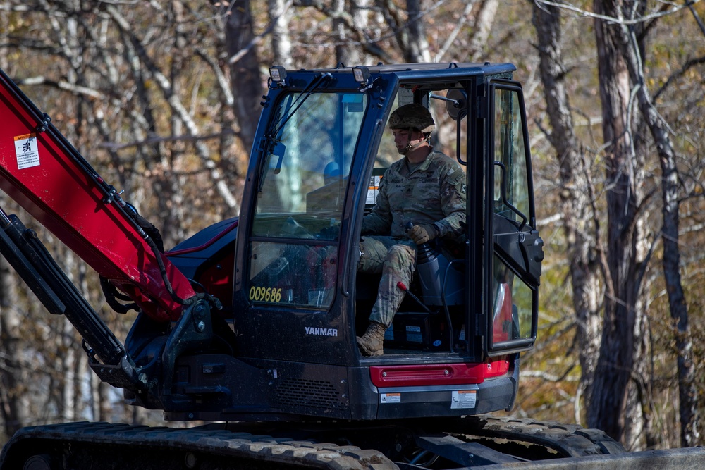 161st Engineer Support Company (Airborne) removes debris during route clearance near Green Creek in Bakersville, North Carolina