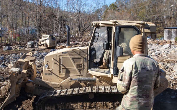 161st Engineer Support Company (Airborne) removes debris during route clearance near Green Creek in Bakersville, North Carolina