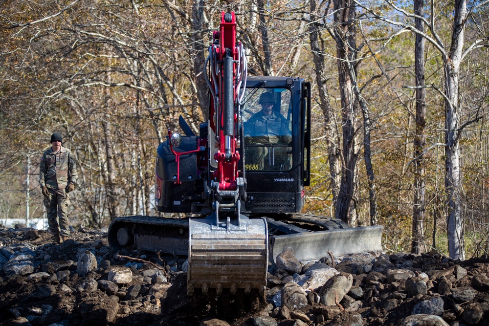 161st Engineer Support Company (Airborne) removes debris during route clearance near Green Creek in Bakersville, North Carolina