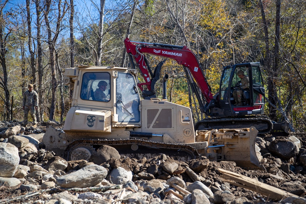 161st Engineer Support Company (Airborne) removes debris during route clearance near Green Creek in Bakersville, North Carolina