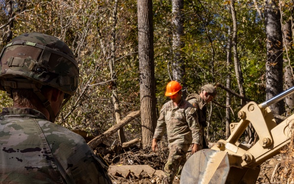 U.S. Army Soldiers assigned to 161st Engineer Support Company (Airborne), 27th Engineer Battalion (Airborne), 20th Engineer Brigade, XVIII Airborne Corps conduct route clearance in Swannanoa, North Carolina, Oct. 18th, 2024.