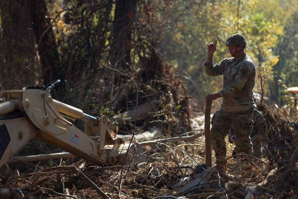 U.S. Army Specialist Corbin Park assigned to 161st Engineer Support Company (Airborne), 27th Engineer Battalion (Airborne), 20th Engineer Brigade, XVIII Airborne Corps conduct route clearance in Swannanoa, North Carolina