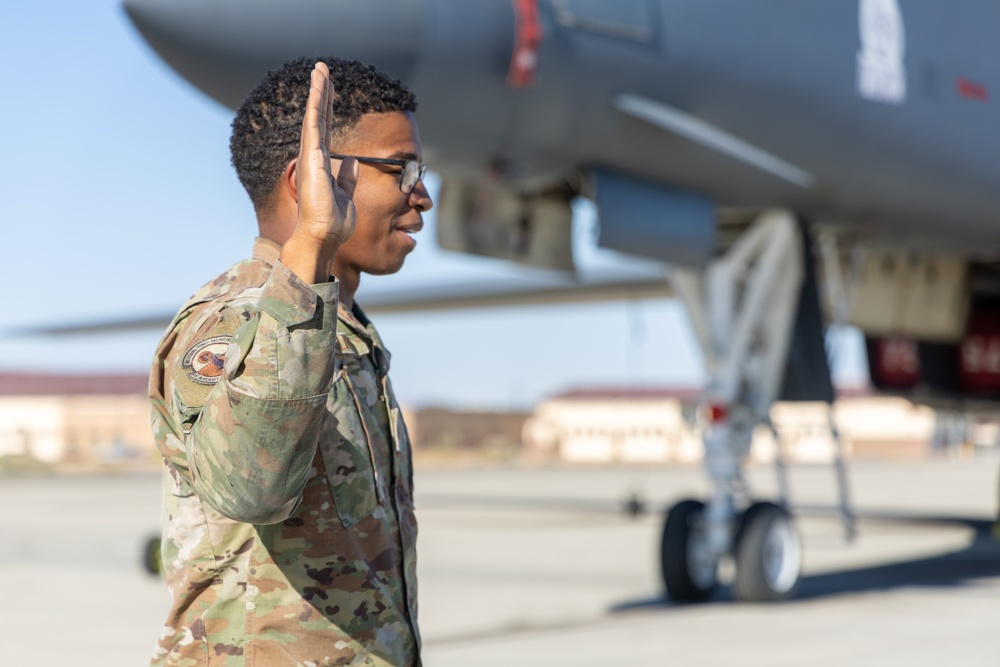 SSgt Xavier Collins, Crew Chief for the 912th Aircraft Maintenance Squadron, swears in for his re-enlistment ceremony in front of a B-1B Bomber at Edwards Air Force Base