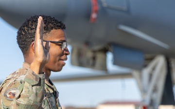 SSgt Xavier Collins, Crew Chief for the 912th Aircraft Maintenance Squadron, swears in for his re-enlistment ceremony in front of a B-1B Bomber at Edwards Air Force Base