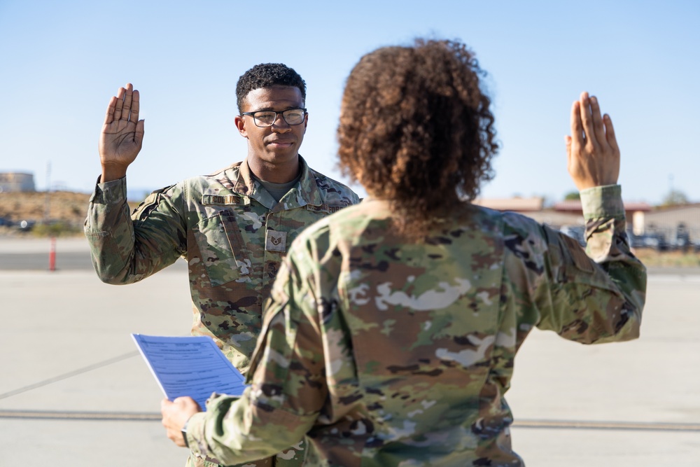 SSgt Xavier Collins, Crew Chief for the 912th Aircraft Maintenance Squadron, swears in for his re-enlistment ceremony in front of a B-1B Bomber at Edwards Air Force Base