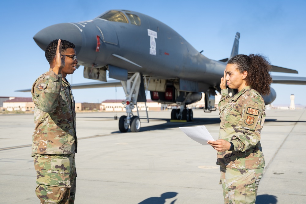 SSgt Xavier Collins, Crew Chief for the 912th Aircraft Maintenance Squadron, swears in for his re-enlistment ceremony in front of a B-1B Bomber at Edwards Air Force Base