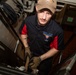 A Culinary Specialist cleans a ladder well