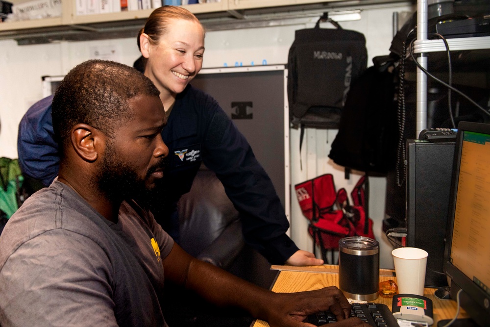 An Intelligence Specialist 2nd Class and the MWR fitness specialist plan MWR events for Sailors aboard USS Carl Vinson (CVN 70)