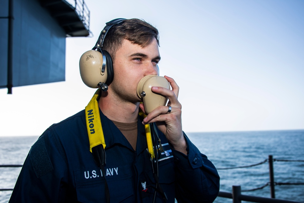 A Boatswain’s Mate 3rd Class stands buoy watch on the fantail