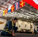 A Quartermaster secures the national ensign in the hangar bay aboard USS Carl Vinson (CVN 70)