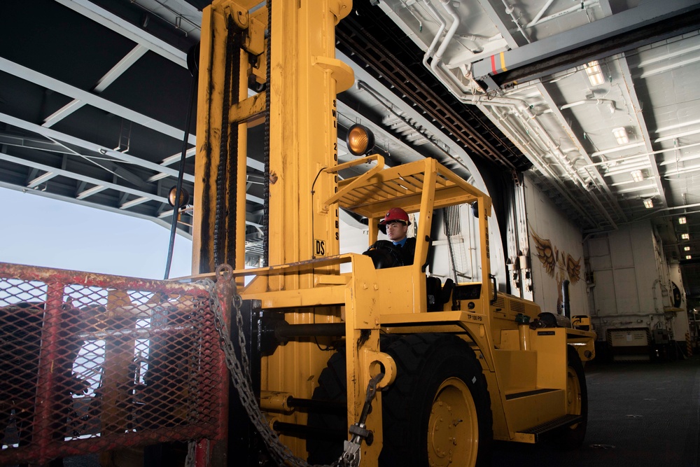 An Aviation Boatswain's Mate (Handling) Operates a Forklift