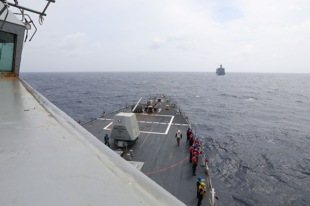 Sailors aboard the USS Howard conduct a replenishment-at-sea with the USNS Rappahannock in the South China Sea