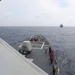 Sailors aboard the USS Howard conduct a replenishment-at-sea with the USNS Rappahannock in the South China Sea