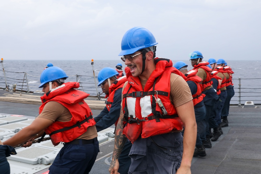 Sailors aboard the USS Howard conduct a replenishment-at-sea with the USNS Rappahannock in the South China Sea