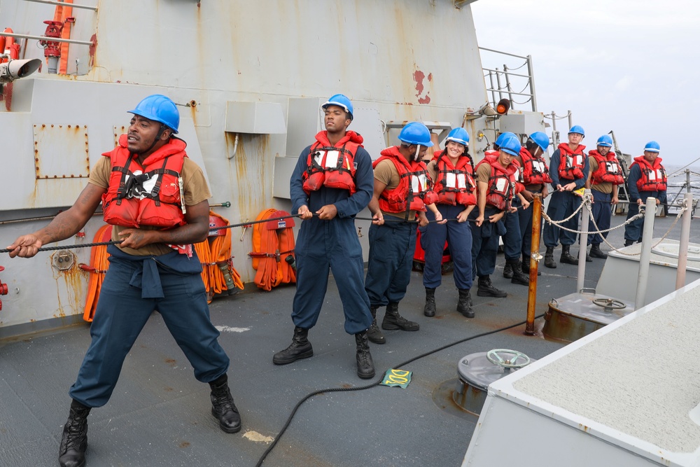 Sailors aboard the USS Howard conduct a replenishment-at-sea with the USNS Rappahannock in the South China Sea