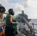 Sailors aboard the USS Howard conduct a replenishment-at-sea with the USNS Rappahannock in the South China Sea