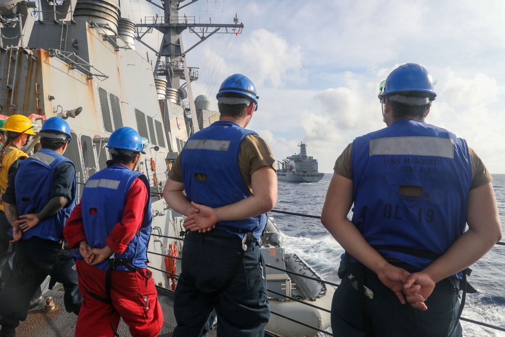 Sailors aboard the USS Howard conduct a replenishment-at-sea with the USNS Rappahannock in the South China Sea