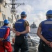 Sailors aboard the USS Howard conduct a replenishment-at-sea with the USNS Rappahannock in the South China Sea