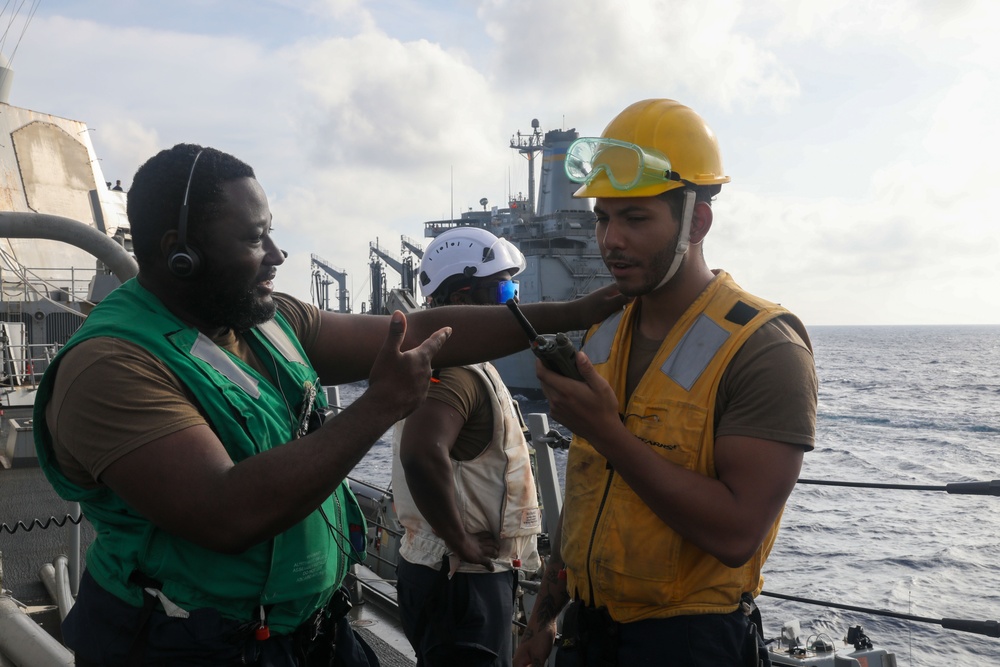 Sailors aboard the USS Howard conduct a replenishment-at-sea with the USNS Rappahannock in the South China Sea