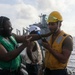 Sailors aboard the USS Howard conduct a replenishment-at-sea with the USNS Rappahannock in the South China Sea