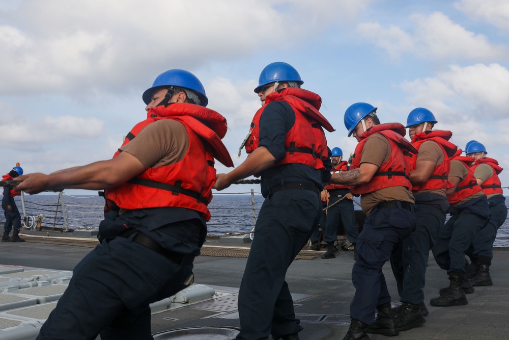 Sailors aboard the USS Howard conduct a replenishment-at-sea with the USNS Rappahannock in the South China Sea