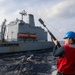 Sailors aboard the USS Howard conduct a replenishment-at-sea with the USNS Rappahannock in the South China Sea