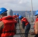 Sailors aboard the USS Howard conduct a replenishment-at-sea with the USNS Rappahannock in the South China Sea